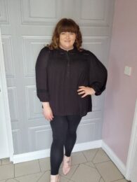 Plus size clothing – Only Carzia black 3/4 sleeve popover blouse with button front detail, styled with leggings.
