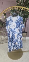 The Watercolour Floral Dress with round neckline, short sleeves, and soft A-line drape – painterly blue floral print from Michelle’s Curvy Boutique.