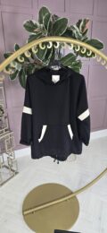 Dipped Hem Black Hoodie with white sleeve detail, kangaroo pocket, and adjustable drawstring hem — relaxed fit casual street style from Michelle’s Curvy Boutique.