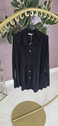 Black Button Peplum Top featuring long sleeves, tiered hem, and faux layered blouse-and-jumper look — available at Michelle’s Curvy Boutique.