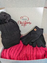 Christmas Gift Box (HGS) with black bobble hat, black gloves and hot pink fluffy scarf arranged in festive gift box.