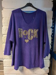 Purple Rock Knitted Jumper – rich purple knit with V-neck, ¾ sleeves, dropped shoulders, and sequined ROCK motif with mixed animal prints.