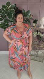 The Peach Paradise Shelly Dress faux wrap midi dress in peach with tropical leaf print and capped sleeves